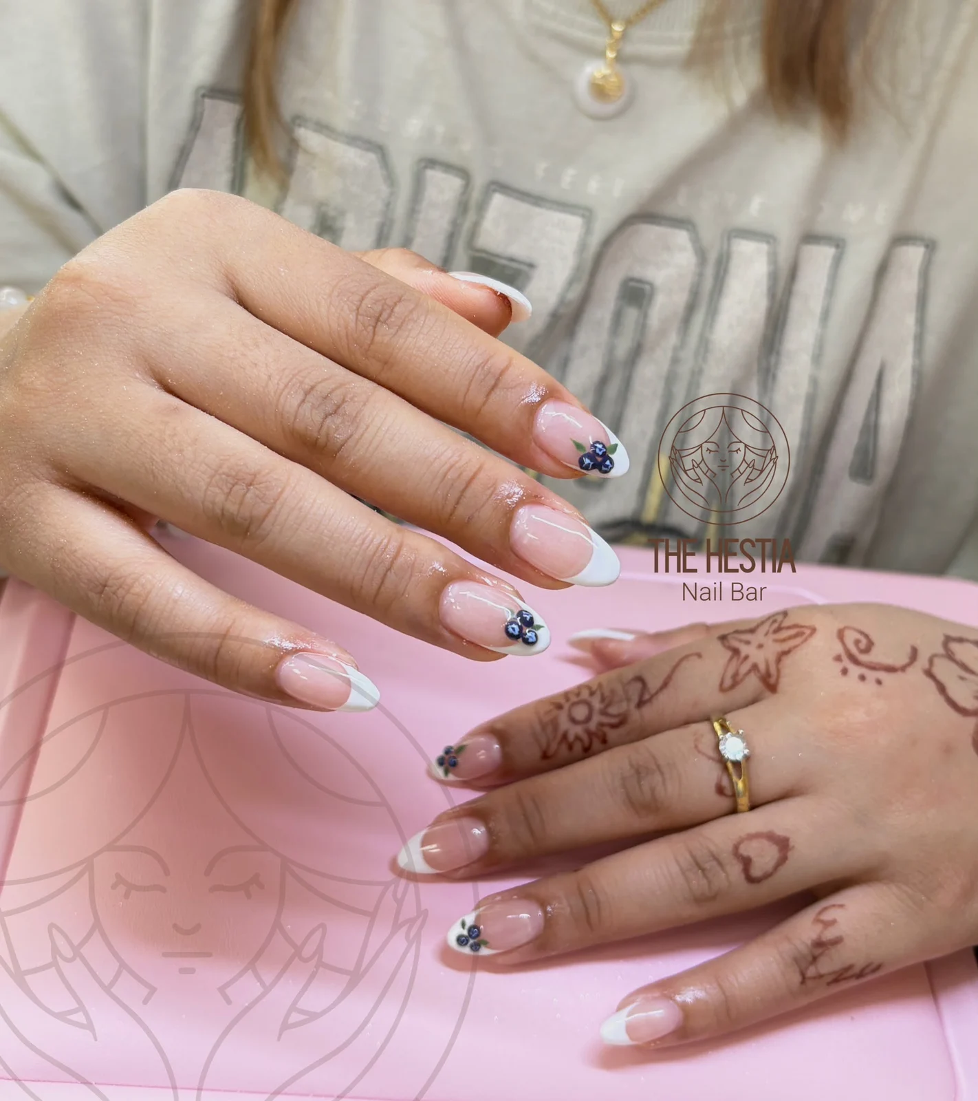 White French manicure with hand-painted blueberry details by The Hestia Nail Bar